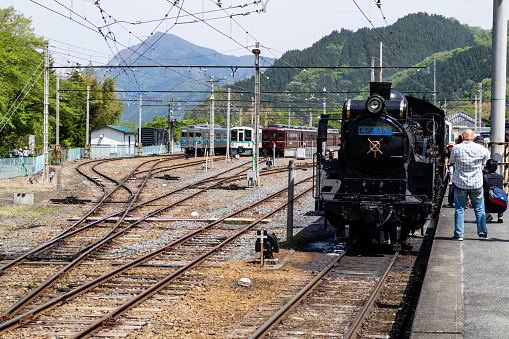 Chichibu, Japan - 05/03/2019: Tourists looking at the famous steam engine in Chichubu, Japan