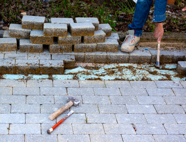 istock Maintenance work on paving with interlocking paving stones. Building materials industry; Concrete products for road or sidewalk construction. 1153378098