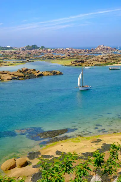 Photo of Breton traditional sailing boat at Saint Guirec at the pink granite coast in Brittany, France