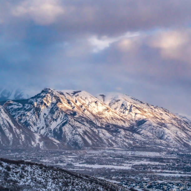 istock Square Majestic mountain covered with snow under blue sky with gray puffy clouds 1153378552
