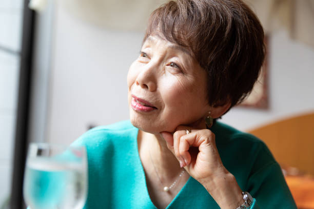 istock Senior woman and wineglass 1153379259