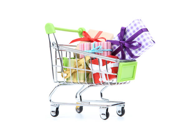 istock Small shopping cart with gift boxes isolated on white background 1153379347