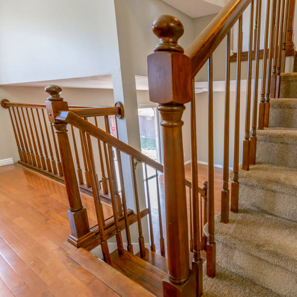 istock Square frame Carpeted staircase with brown handrail inside a house with shiny wooden floor 1153379351