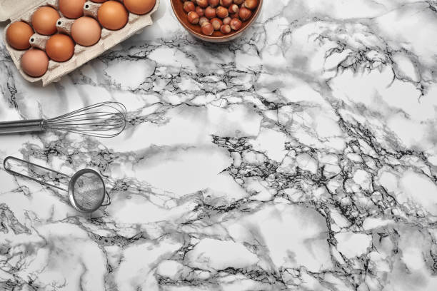 istock Close-up shot. Top view of a baking ingredients and kitchenware on the marble table background. 1153380507