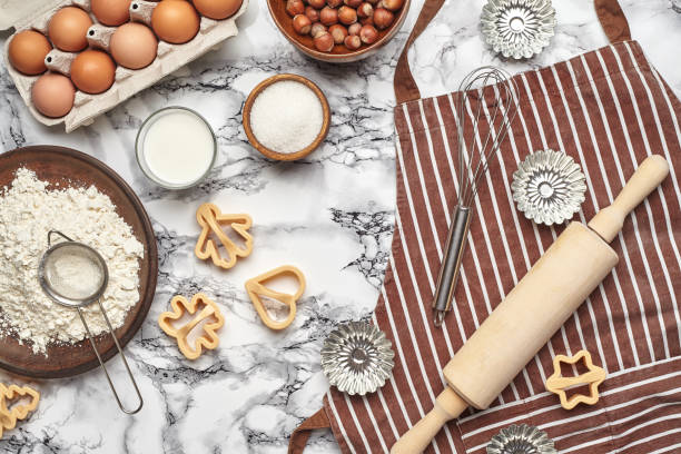 istock Close-up shot. Top view of a baking ingredients and kitchenware on the marble table background. 1153380522