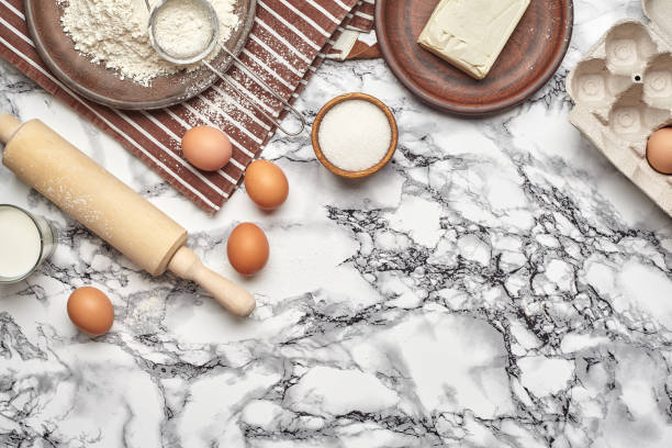 istock Close-up shot. Top view of a baking ingredients and kitchenware on the marble table background. 1153380609