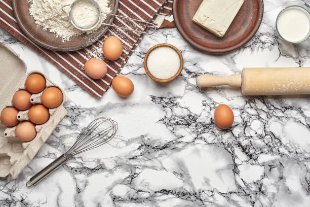 istock Close-up shot. Top view of a baking ingredients and kitchenware on the marble table background. 1153380618