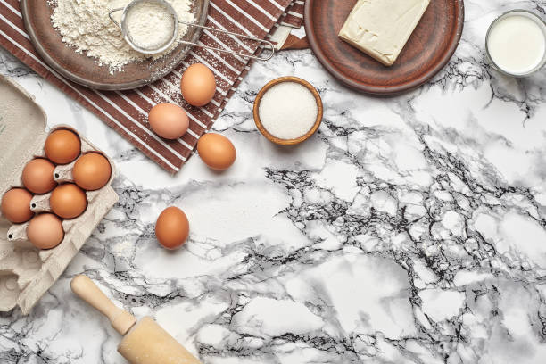 istock Close-up shot. Top view of a baking ingredients and kitchenware on the marble table background. 1153380630