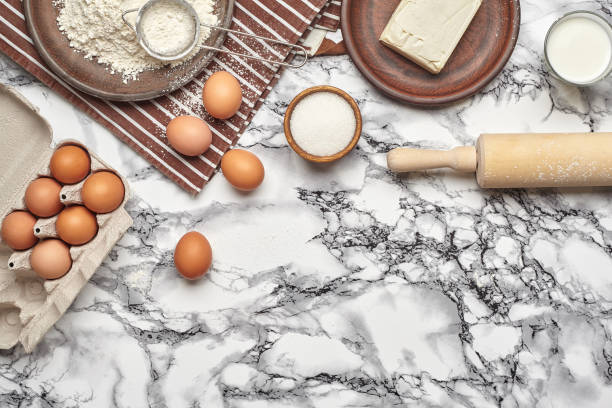 istock Close-up shot. Top view of a baking ingredients and kitchenware on the marble table background. 1153380663