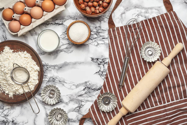 istock Close-up shot. Top view of a baking ingredients and kitchenware on the marble table background. 1153380792