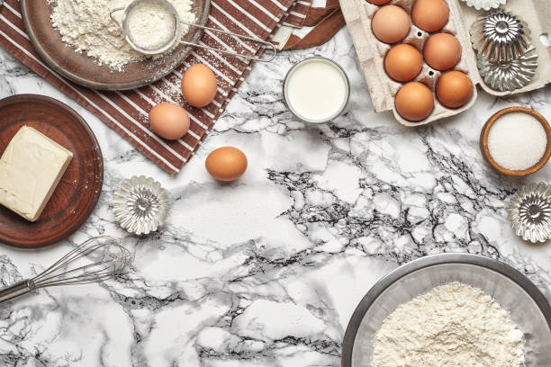 istock Close-up shot. Top view of a baking ingredients and kitchenware on the marble table background. 1153380815