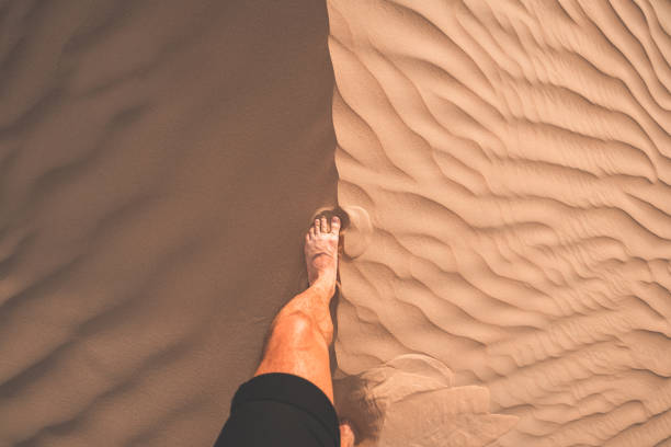 istock POV of a man exploring the desert during sunset 1153381452