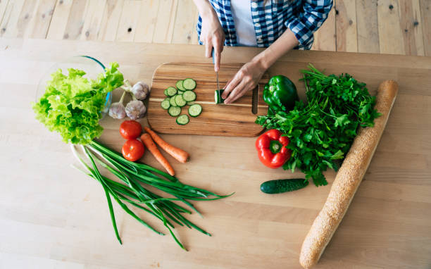 istock Female hands cutting vegetables in the kitchen. 1153381611