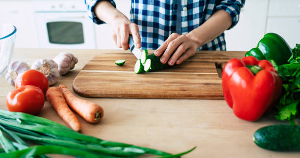 istock Female hands cutting vegetables in the kitchen. 1153381626