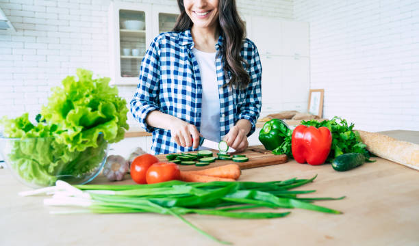 istock Female hands cutting vegetables in the kitchen. 1153381628