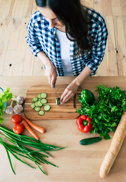 istock Female hands cutting vegetables in the kitchen. 1153381647