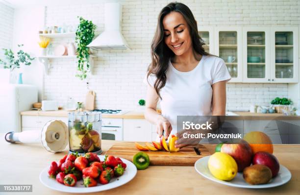 Beautiful Woman Making Fruits Smoothies With Blender Stock Photo - Download Image Now