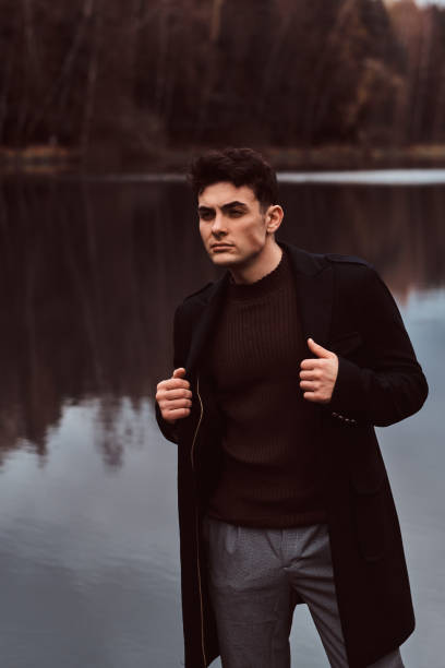 istock A confident young handsome man in the autumn forest. 1153382935