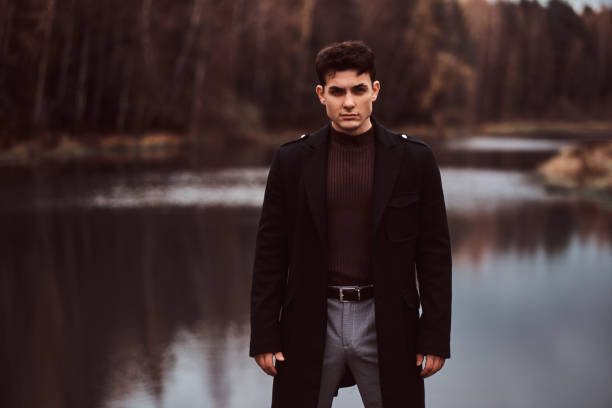istock A confident young handsome man in the autumn forest. 1153383114