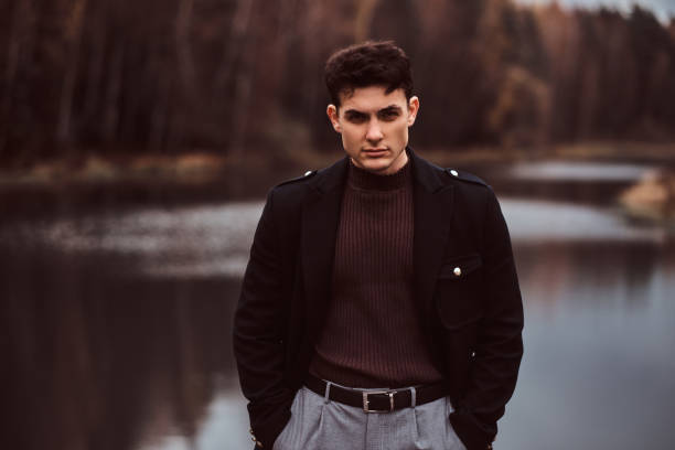 istock A confident young handsome man in the autumn forest. 1153383266