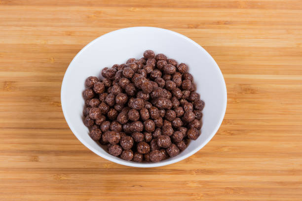 istock Breakfast cereal chocolate balls in bowl on a wooden surface 1153383628