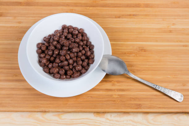 istock Breakfast cereal chocolate balls in bowl on a wooden surface 1153384585