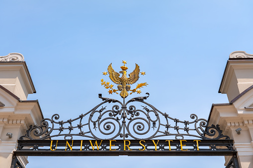 Warsaw University Coat of Arms from 1916 at the Main Gate in Warsaw, Poland. Gilded, crowned eagle with five stars which symbolise the first five faculties of the University.