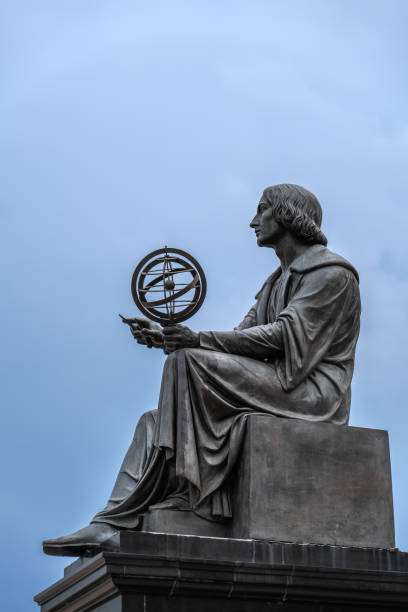 Nicolaus Copernicus Monument in Warsaw, Poland, bronze statue of a Polish astronomer from 1830 holding a compass and armillary sphere.