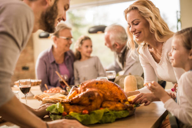 istock Happy family making final preparation on Thanksgiving day. 1153385910