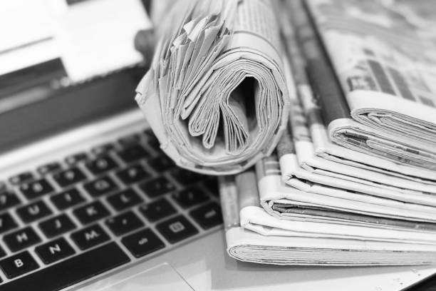 istock Newspapers and Laptop 1153387626