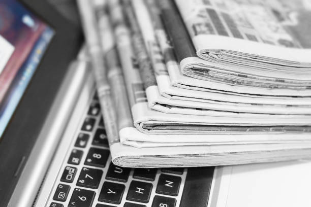 istock Newspapers and Laptop 1153387691