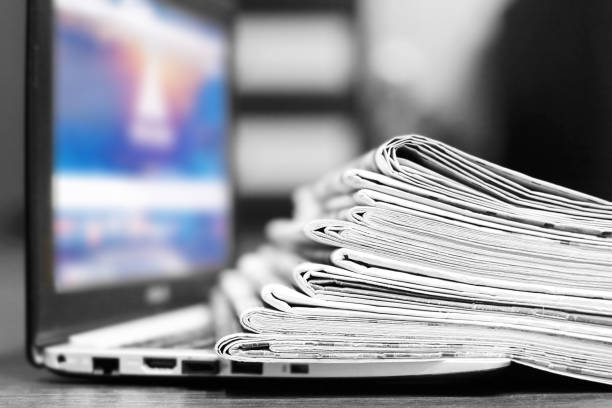 istock Newspapers and Laptop 1153387950