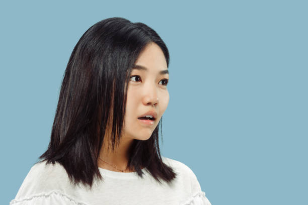 istock Korean young woman's half-length portrait on blue background 1153388012