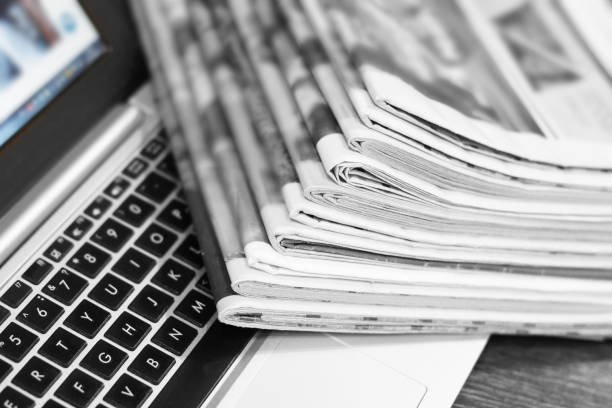 istock Newspapers and Laptop 1153388033