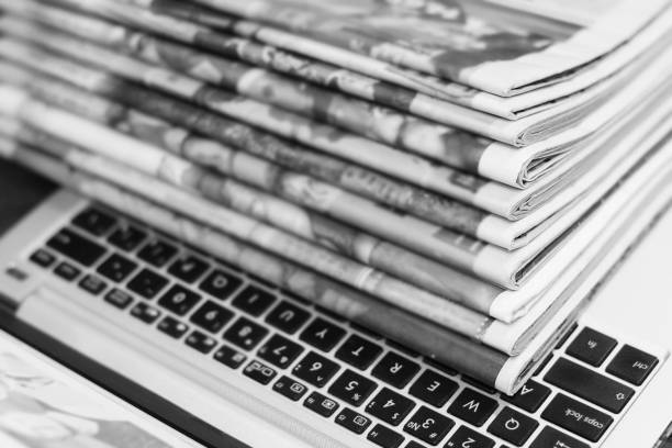 istock Newspapers and Laptop 1153388042