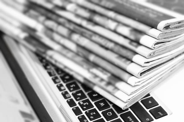 istock Newspapers and Laptop 1153388296