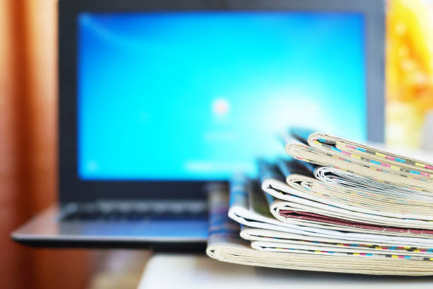 istock Newspapers and Laptop 1153388481