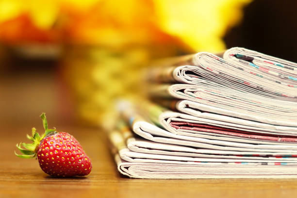 Newspapers and Strawberry stock photo