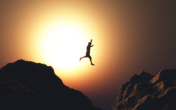 istock 3D male figure jumping from one mountain to another 1153390383