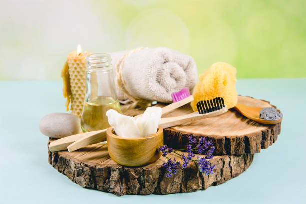 istock Using natural material products in home, different cosmetic products in bathroom. Minimizing ecological footprint concept. Bamboo bath towel, biodegradable bamboo toothbrush, clay mask, coconut oil. 1153391173