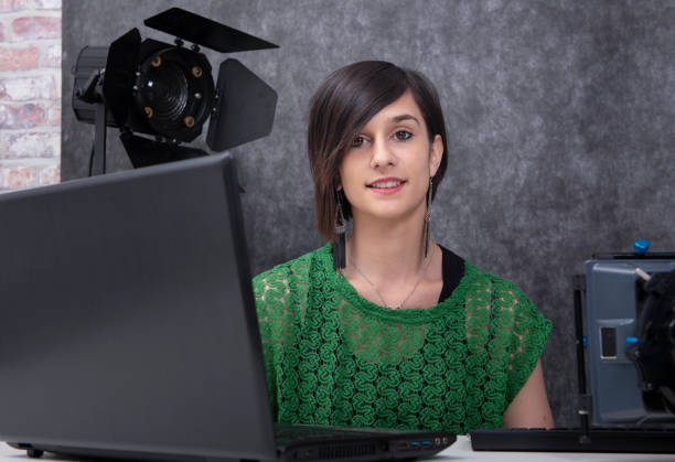 istock pretty young woman video editor working in studio 1153391197