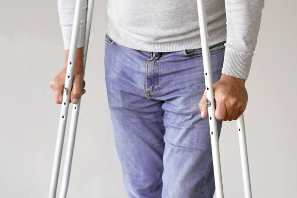 istock Man with crutch. Close-up. Side view 1153393559