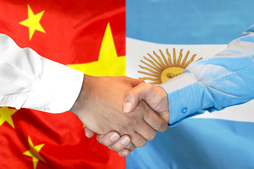 Business handshake on the background of two flags. Men handshake on the background of the China and Argentina flag. Support concept