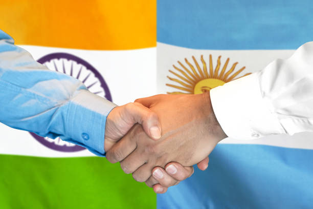 istock handshake on Argentina and India flag background. 1153395687