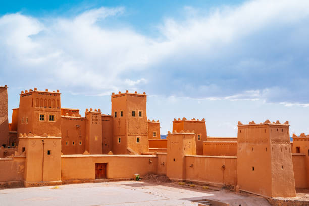 Morocco, Kasbah Taourirt fortress on a sunny day with cloudy sky. Fortress Kasbah Taourirt in a sunny day. Blue cloudy sky on the background. casbah stock pictures, royalty-free photos & images