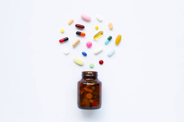 istock Colorful tablets with capsules and pills on white. 1153398738