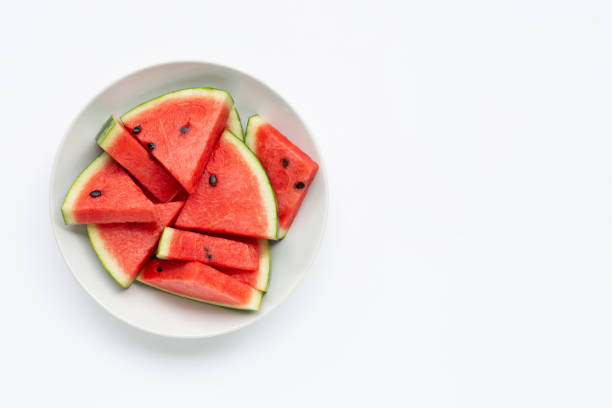istock Summer fruit, Slices of watermelon on white plate isolated on white background 1153400199