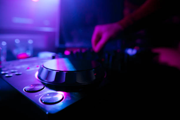 istock DJ mixing tracks on a mixer in a nightclub 1153402953