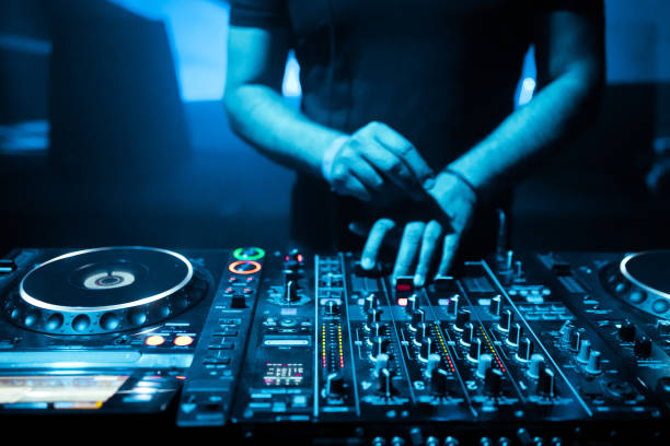 istock DJ mixing tracks on a mixer in a nightclub 1153403148