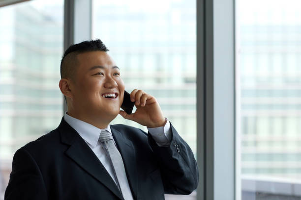 istock Businessman talking on smart phone at office 1153404707